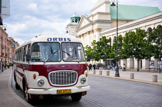 Retro city bus Orbis near old town buildings on street Warsaw Poland June 24 2025
