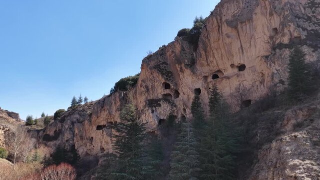 An aerial drone shot of the rugged cliffs of Seren&ccedil;ay Canyon in Burdur and the ancient cave settlements within it.