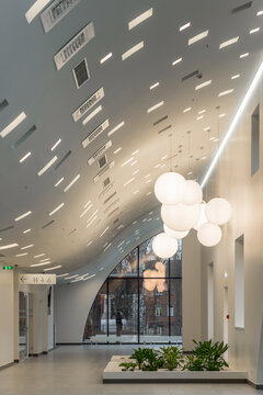 Modern hospital atrium interior with large windows and minimalist architecture.