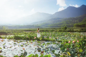 Fotobehang Lotusbloem Wide Lotus Field Landscape At Sunrise, Thai Binh Vietnam With Model  © Buyanskyy Production