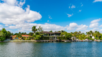 Fototapeta premium Hotel building at palm tree. Residential architecture. Modern building. Residential apartment in waterfront city. Waterfront landscape with house. Vacation building in summer. Luxury waterfront house