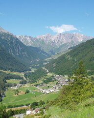 Fototapeta premium Italian alps valley with alpine village and mountain peaks