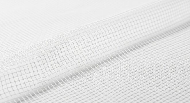 Close-up of fine white mesh fabric with subtle grid pattern and soft lighting