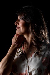 Woman planning carefully, Thoughtful female silhouette contemplating with quiet purpose, Woman in dim lighting carefully strategizing her next move with intent focus © fotodrobik