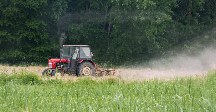 Agricultural tractor working in a field during harvest
