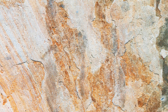Closeup natural sandstone texture with layered erosion marks and mineral streak patterns