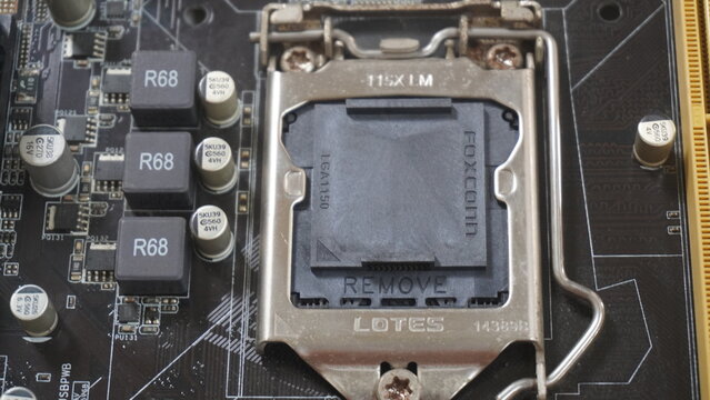 Purwokerto, Indonesia - 17 March 2026: Close-up of a Lotes CPU socket protective cover on a motherboard with visible capacitors and circuitry.
