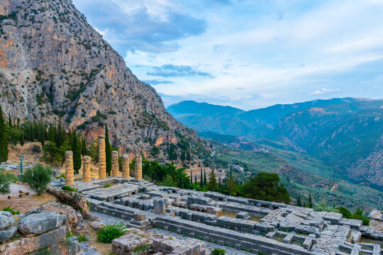 Panoramic evening view of Delphi archeological site in Central Greece with temple of Apollo and valley in the distance