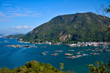 Obraz premium Traditional fish farm rafts in the turquoise waters of Sok Kwu Wan, Lamma Island, Hong Kong.