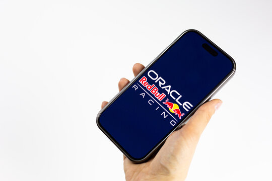 Moscow, Russia, March 14, 2026: Smartphone in hand showing Oracle Red Bull Racing logo on display, isolated on white background. F1 news about team new era with Red Bull Ford Powertrains