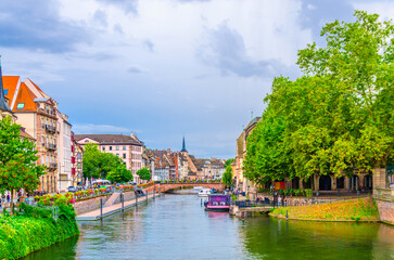 Obraz premium River Ill canal water, Quai des Bateliers embankment with medieval buildings old houses in old town Strasbourg city historic Centre Ville Grande ile Grand Island, Alsace Grand Est region, France