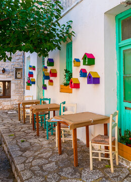 Birdhouse decoration with chairs and tables on the street of the Greek village Areopoli in Mani region, Laconia, Greece