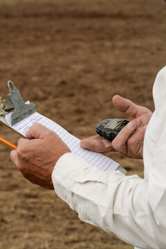 Wagon Mound, New Mexico, United States.  99th annual Bean Days rodeo and celebration. Judge times bull riders.