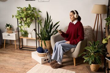 Fototapeta premium Charming moments of relaxation for a young woman in her stylish apartment