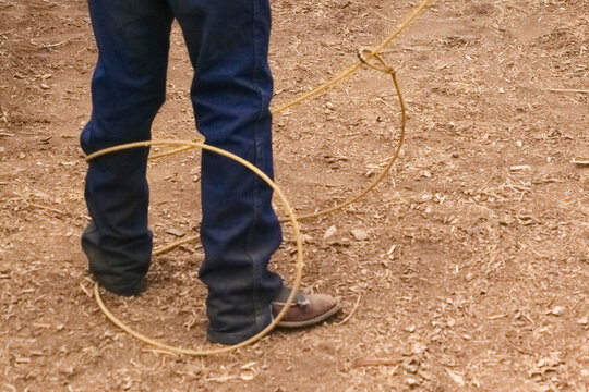 Galisteo, New Mexico, United States.  39th annual small town Galisteo authentic old western rodeo. Boy about to get lassoed.