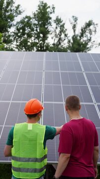 An engineer explains to a client how solar panels work. High quality 4k footage