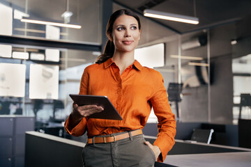 European young businesswoman CEO holding digital tablet using fintech tab, looking dreaming at copy...