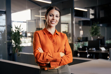 Portrait of beautiful successful hispanic young business woman with crossed arms smiling at camera. Latin or eastern confident middle age female ceo leader businesswoman standing in office. Copy space © Stock 4 You