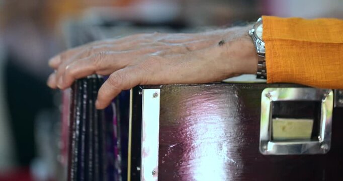 Close-up of harmonium playing during bhajan, showcasing rhythm, melody, and traditional Indian devotional music performance