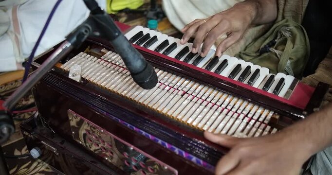 Close-up of harmonium playing during bhajan, showcasing rhythm, melody, and traditional Indian devotional music performance