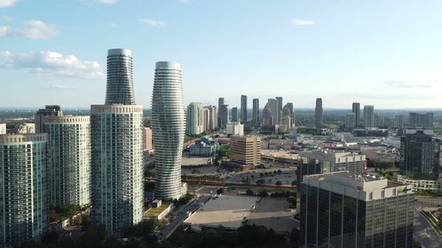 Aerial view of the landmark Absolute buildings and downtown Mississauga, Ontario, Canada. Shot on a beautiful summer late afternoon. Moving forward from a high angle.