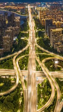 Urban antenna time-lapse at night with interstate traffic, city lights and city lifestyle.