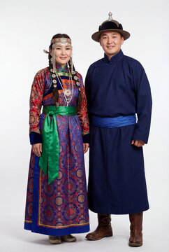 Mongolian couple in traditional deel clothing and hats on white background
