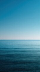 Obraz premium Calm Blue Sea Horizon and Serene Clear Sky