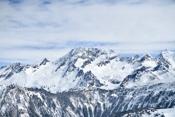 Fototapeta premium View of snowcapped mountains of French alps by winter on sunny day