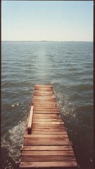 Fototapeta premium Rustic Wooden Pier Leading to Calm Water and Distant Horizon