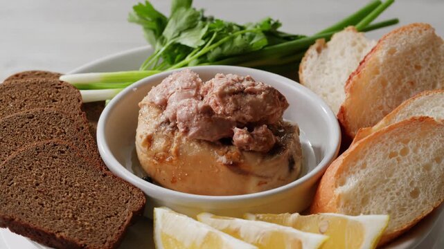 Cod liver superfood can, omega 3 Smoked cod liver in oil in open tin can with fresh greens on wooden table. Seafoods delicacy