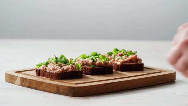 Cod liver superfood can, omega 3 Smoked cod liver in oil in open tin can with fresh greens on wooden table. Seafoods delicacy