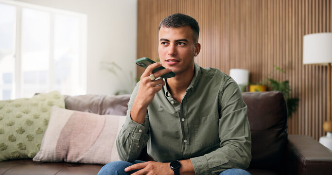 Man, conversation and voice note with speaker phone for audio message or recording in home. Male person, talking or speaking with technology for chat, vocal app or discussion in house living room