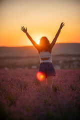 Lavender field woman raising arms celebrating freedom during golden sunset © svetograph