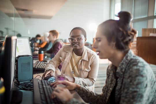 Students collaborating on computers in modern computer lab