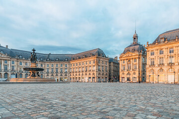 Fototapeta premium Place de la Bourse and Three Graces fountain historic square with classical architecture in Bordeaux city center, Gironde, Nouvelle-Aquitaine, France. French city square. Travel and touristic landmark
