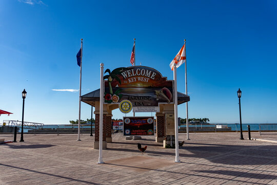 Welcome to Key West Paradise USA Sign with Flags and Roosters at Mallory Square