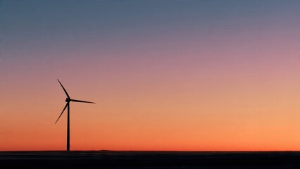 Obraz premium Wind Turbine Silhouette Against Vibrant Sunset Sky