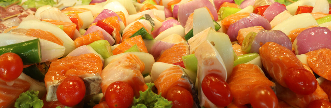 Salmon meat and vegetables on stick fish meal kebab skewer. Quality seafood sea food concept