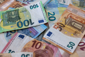 Obraz premium Colorful background with money, euro of different values. Top view of business concept with finance for banks. European banknotes 5, 10, 20, 50, 100 euro on background.