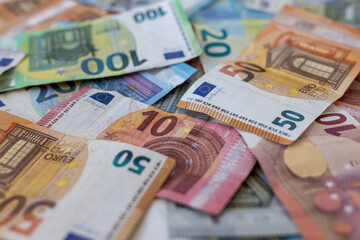 Obraz premium Colorful background with money, euro of different values. Top view of business concept with finance for banks. European banknotes 5, 10, 20, 50, 100 euro on background.