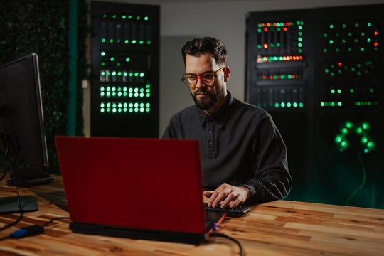 It technician analyzing data in server room