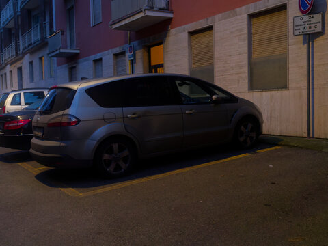 Silver Ford S-Max parked in a residential area at dusk