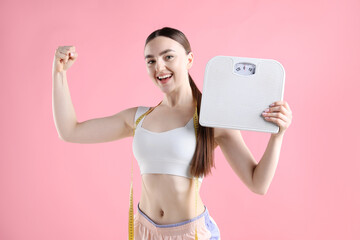 Woman with scales and measuring tape on pink background