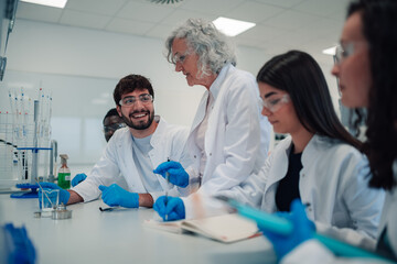 Students and teacher collaborating during science lab experiment