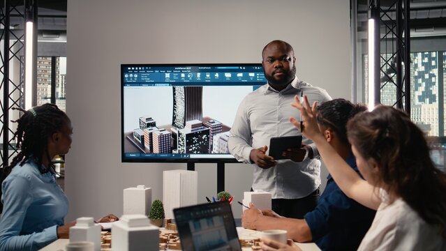 Property developer leads the planning session with 3D models for details and zoning regulations, focusing on site development and infrastructure growth for housing and urban development.
