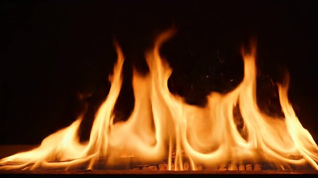 Close-up of flames dancing against a dark background, showcasing orange and yellow hues