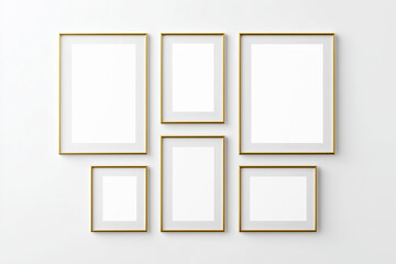 Collection of elegant gold picture frames arranged on a light wall forming a stylish gallery layout
