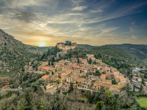 Aerial view of Castelnou one of the most beautiful villages of France with dramatic sunset sky