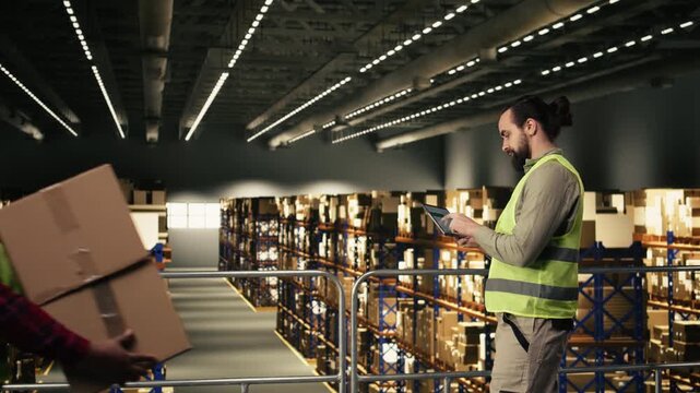 Warehouse employee, tracking software, tablet in warehouse, standing on platform and ensuring express delivery for order fulfillment. Airway bill data for e-commerce operations.